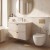 Kaszmirowa łazienka z marmurową ścianą: Aquameb Andora kaszmir mat, szafka pod umywalkę z 2 szufladami, złota armatura i podwieszane WC